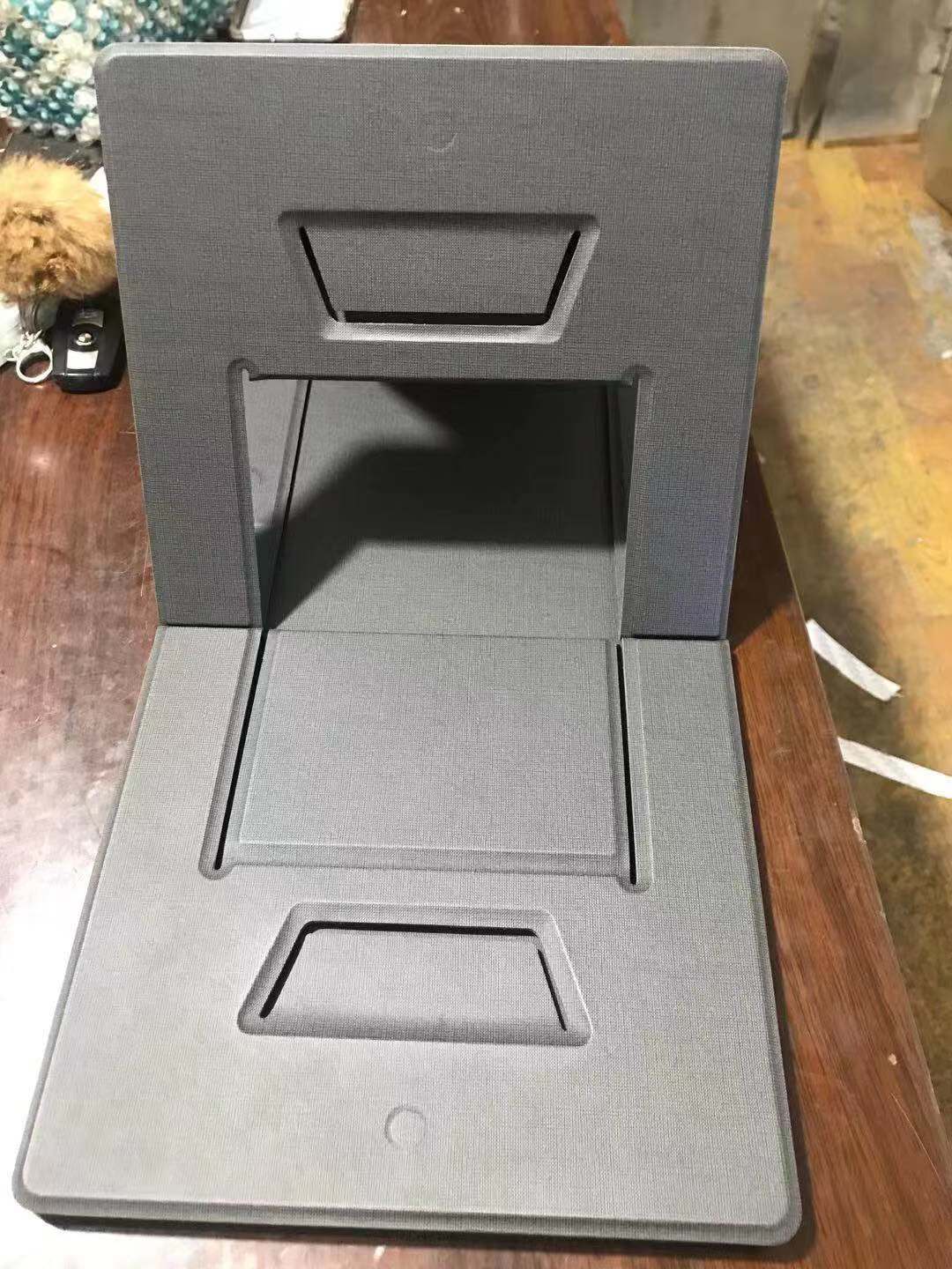 Gray phone stand on a wooden surface