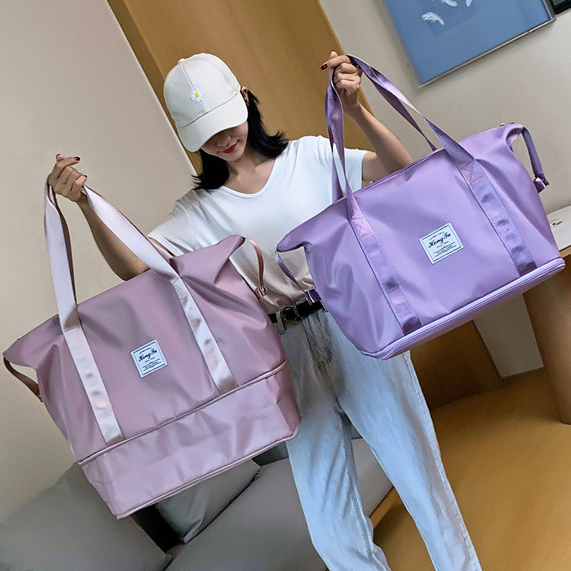 Person holding two pink and purple bags indoors