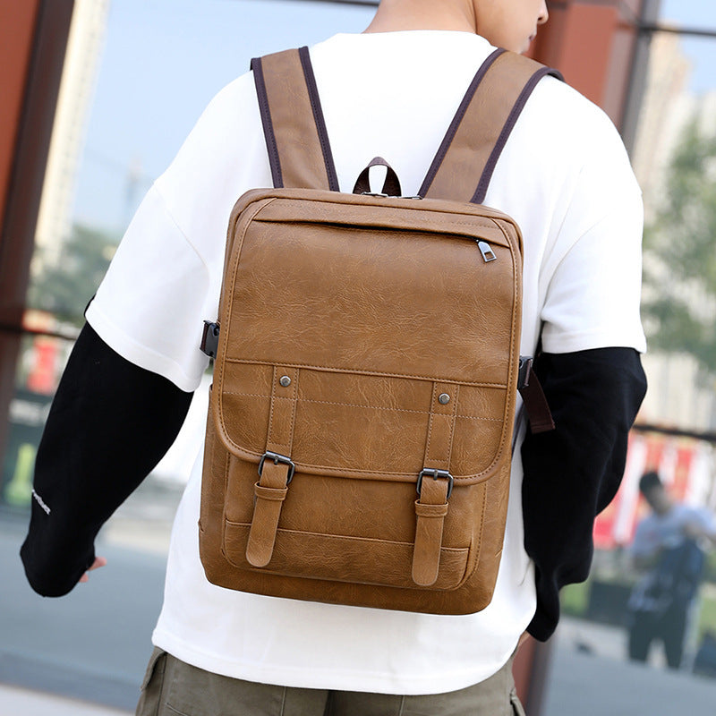 Person wearing a brown backpack with a blurred background