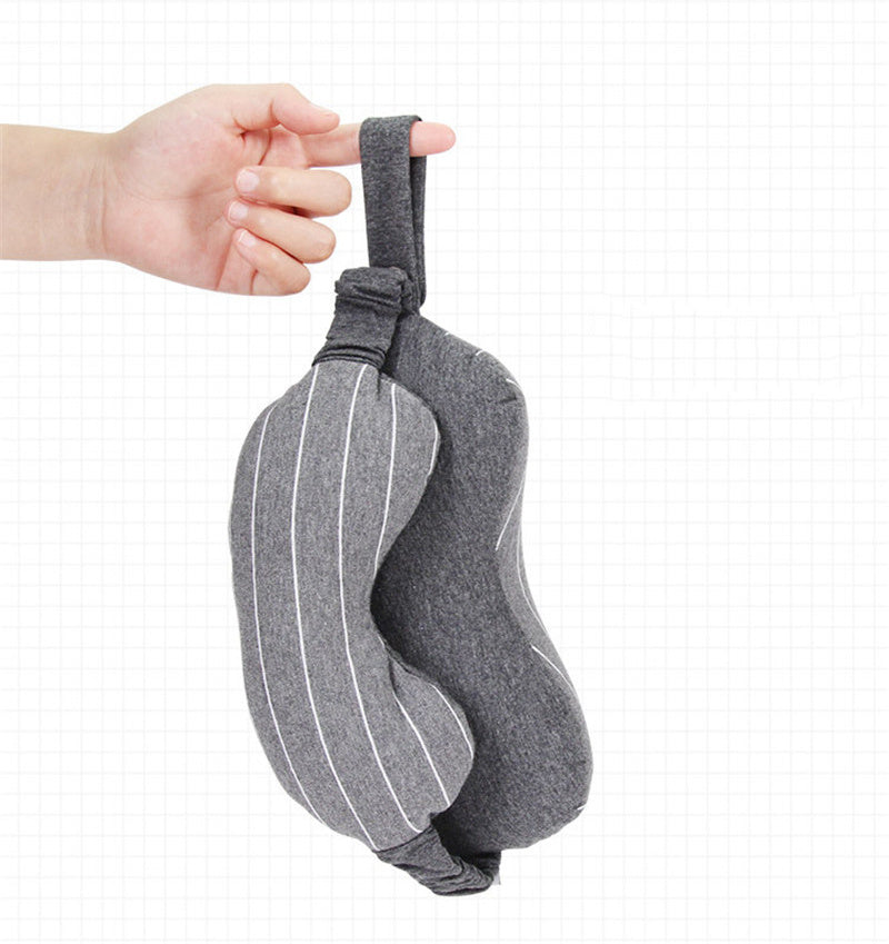 Gray sleep mask held by a hand on a white background