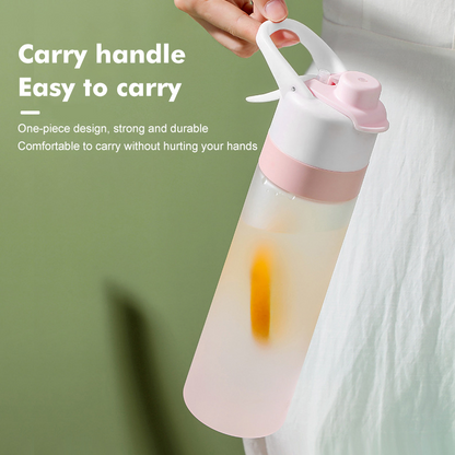 Pink and white water bottle with handle on a green background