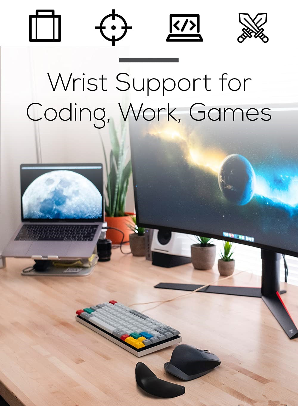 Desk setup with computer monitor, laptop, keyboard, and wrist support on a wooden desk.