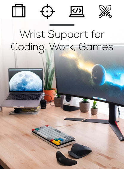 Desk setup with computer monitor, laptop, keyboard, and wrist support on a wooden desk.