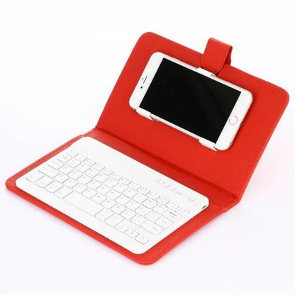 Red case with white keyboard and smartphone on a white background