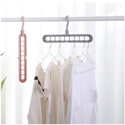 Hanging clothes dryer rack with clothes on a white background