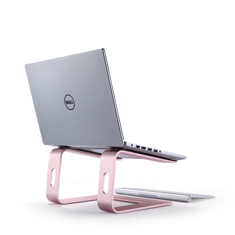 Laptop on a pink stand with a white background