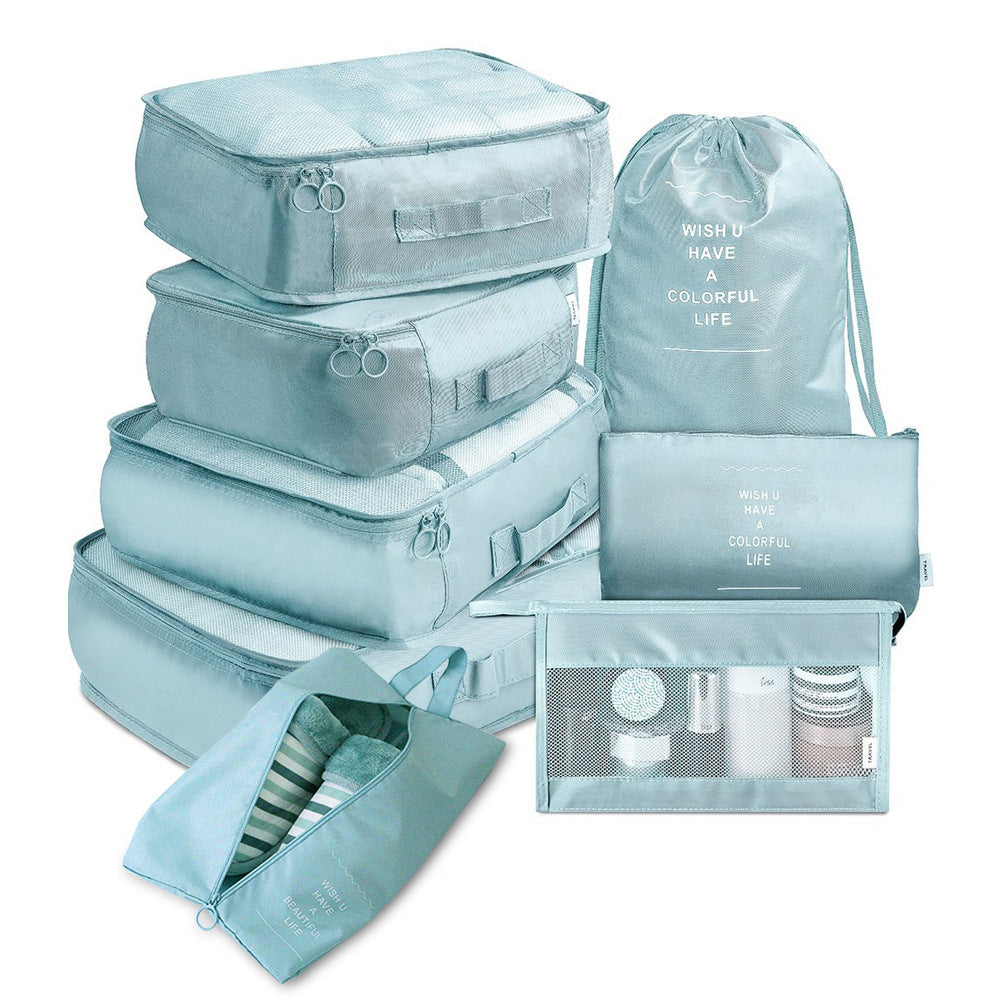 Set of light blue packing cubes and bags on a white background