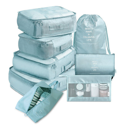 Set of light blue packing cubes and bags on a white background