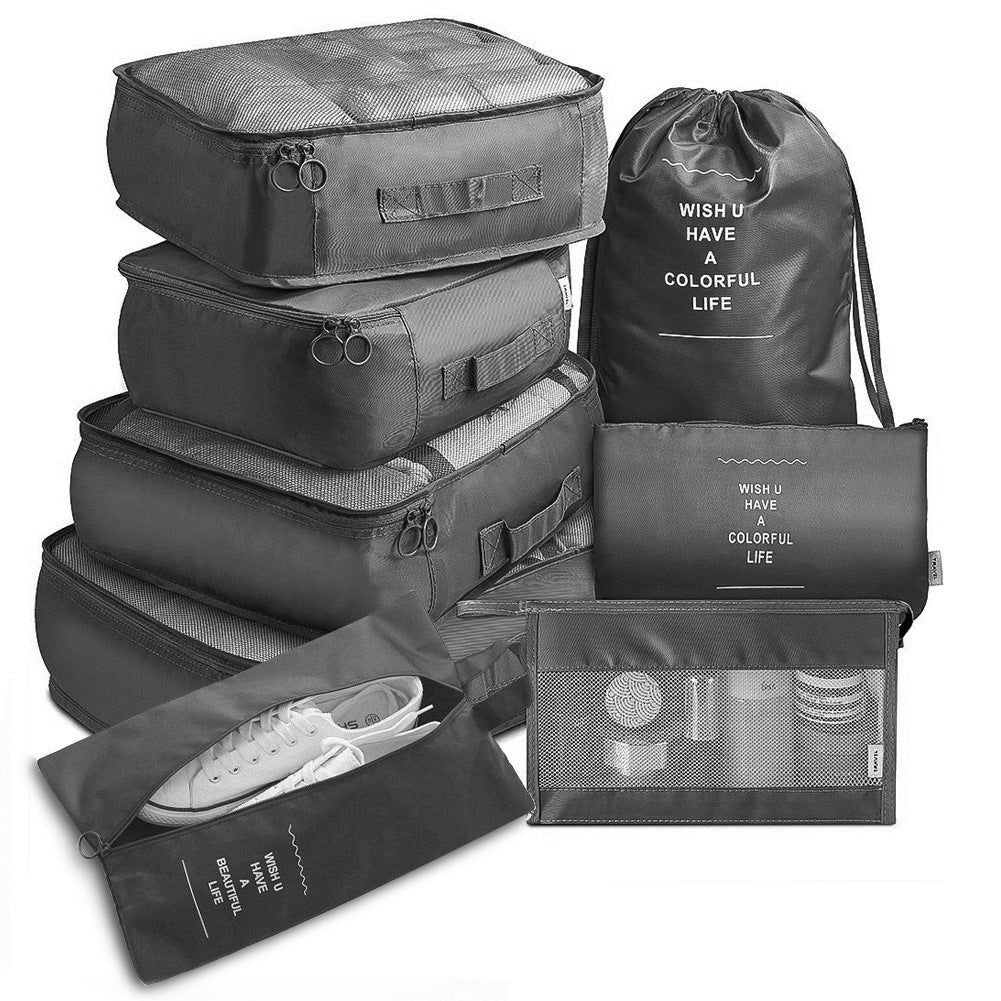 Set of black packing cubes and bags with motivational text on a white background