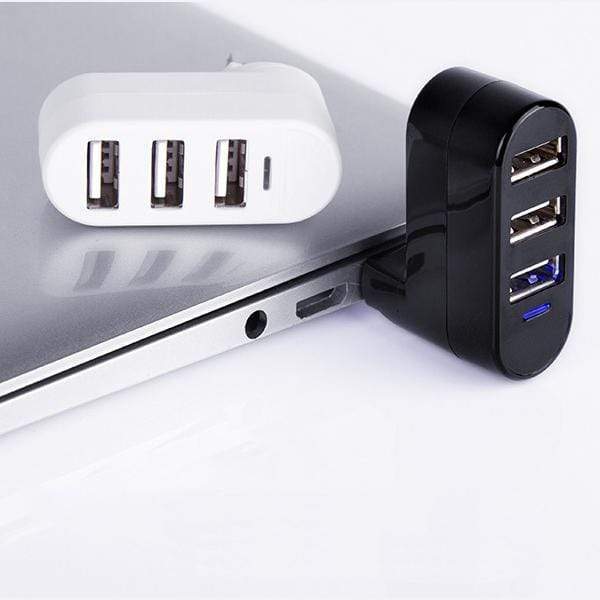 Black USB hub attached to a laptop on a white background