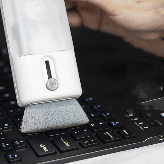Keyboard cleaning brush being used on a laptop keyboard