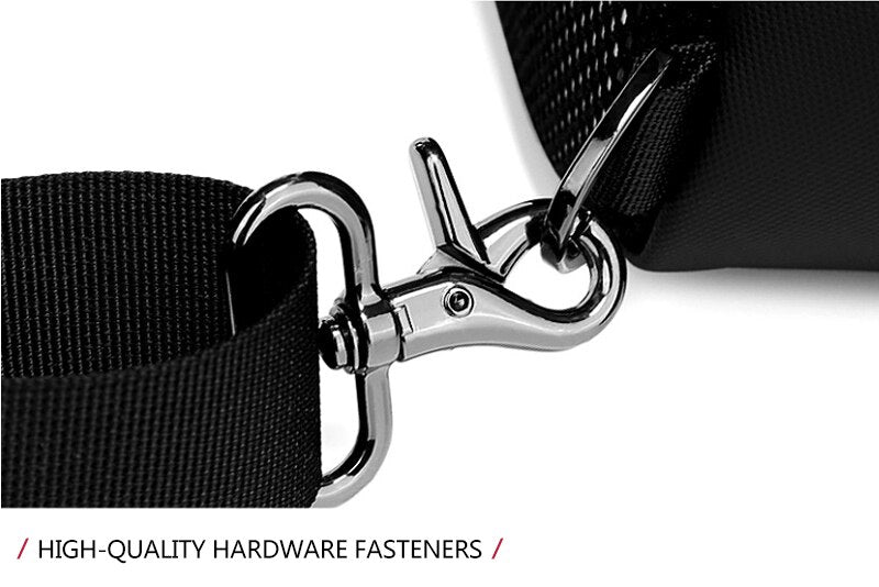 Close-up of a black strap with a silver hardware fastener on a white background