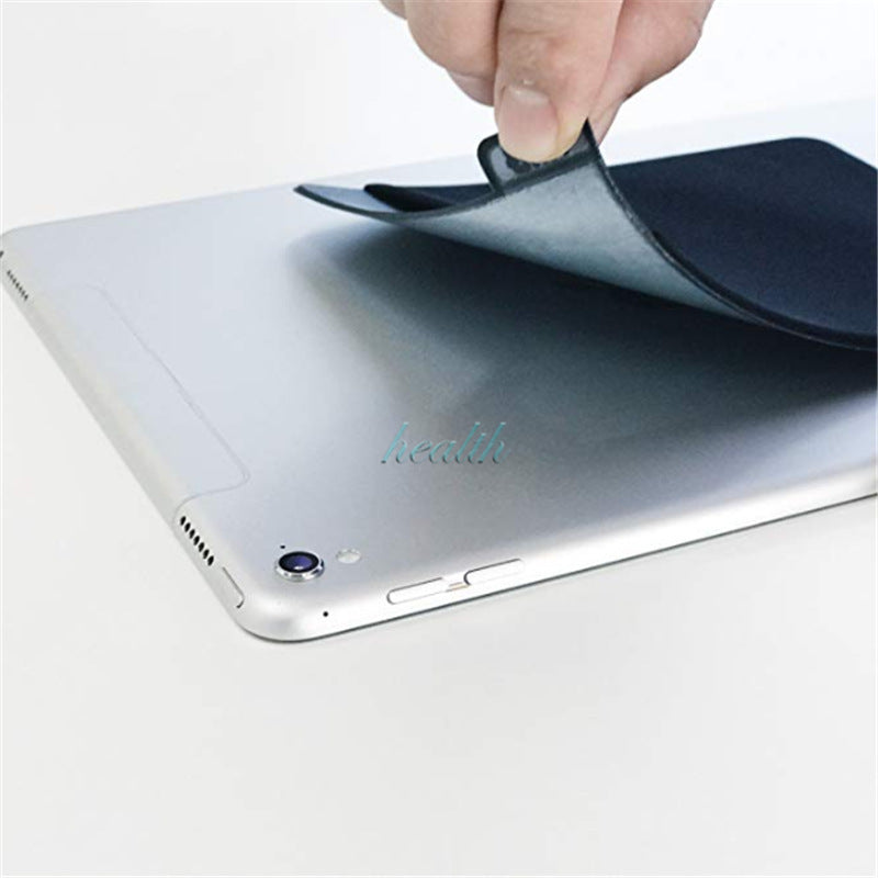 Person applying a screen protector to an iPad