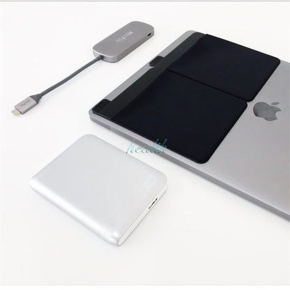 Small electronic device with cable on a white surface