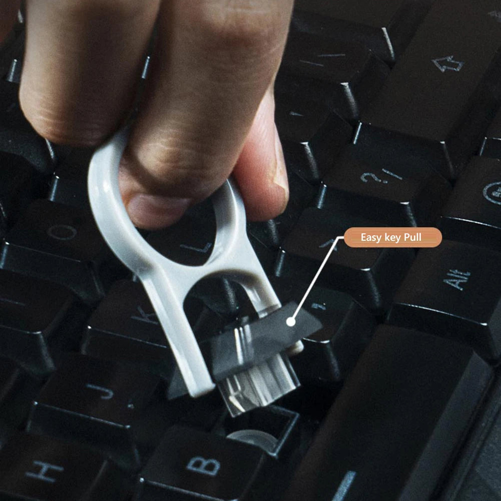 Hand using a key puller tool on a keyboard with an 'Easy key Pull' label.