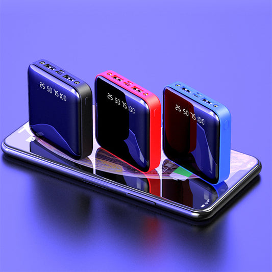 Three portable power banks in blue, red, and black on a reflective surface with a purple background.