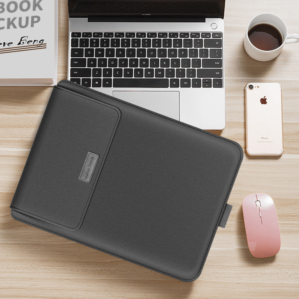 Black laptop sleeve on a desk with a laptop, phone, and mouse.