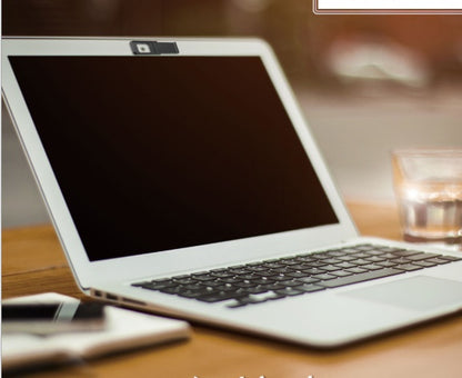 Laptop on a wooden desk with a blurred background
