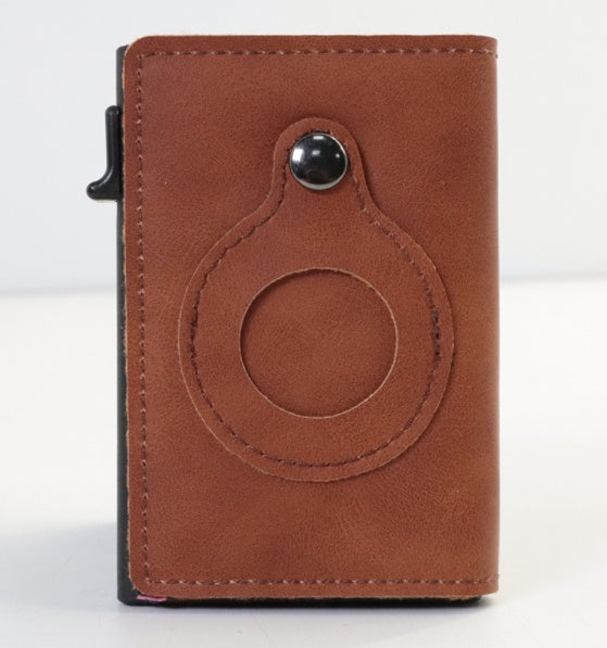 Brown leather cardholder with circular design on a white background