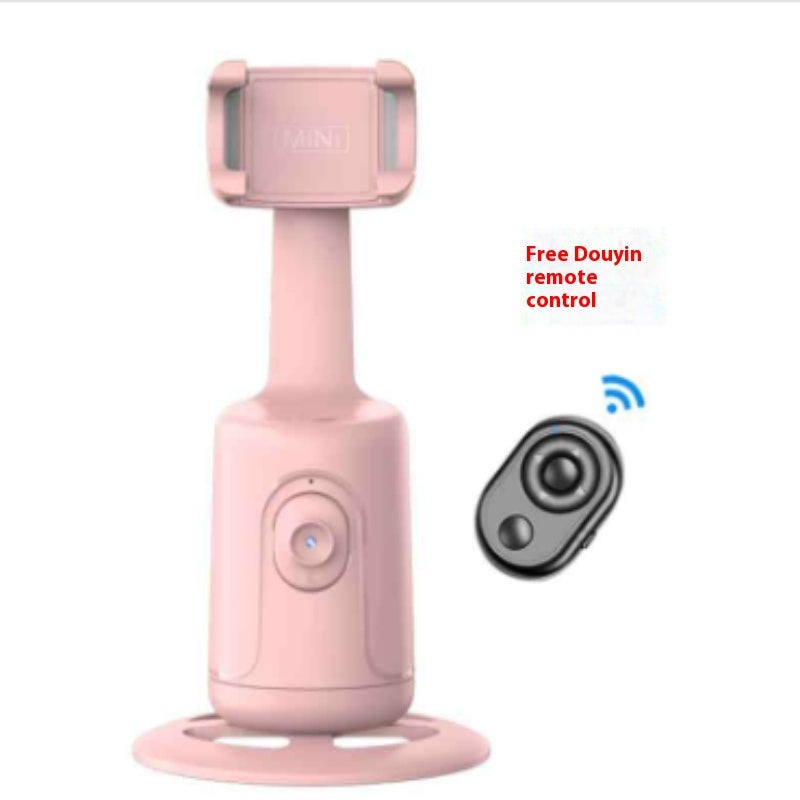 Pink handheld device with a small remote control on a white background