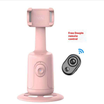 Pink handheld device with a small remote control on a white background