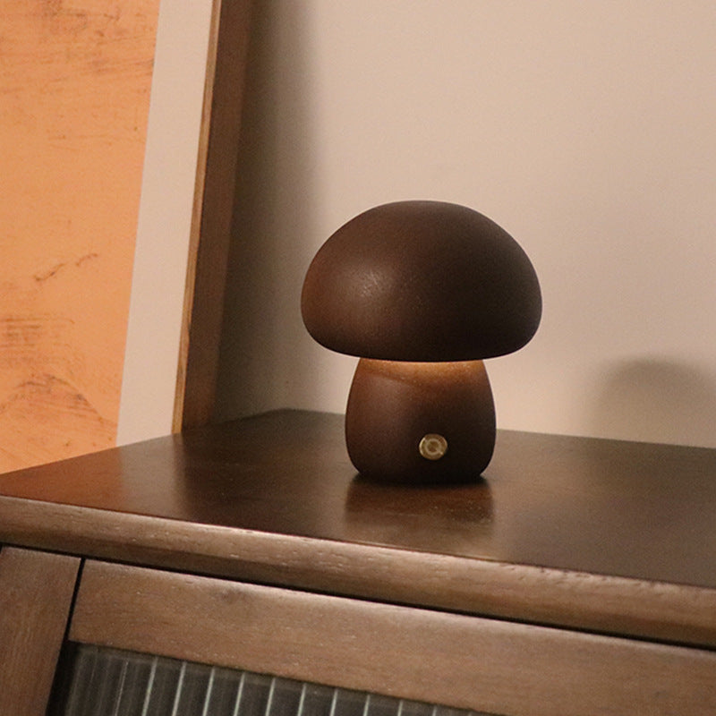 Mushroom-shaped lamp on a wooden surface with a neutral background