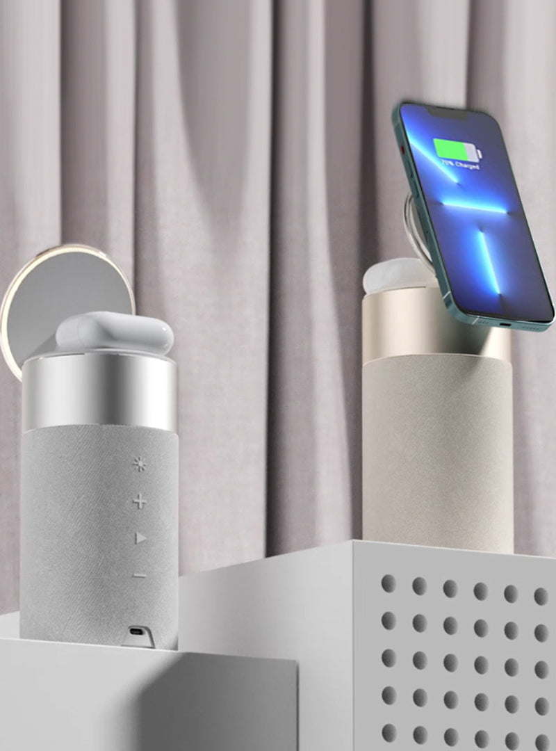 Wireless charging station with phone and speakers on a neutral background