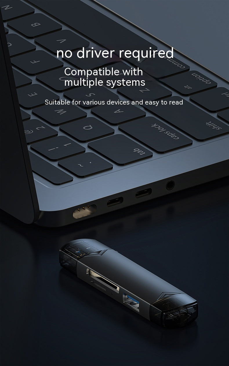 Laptop with USB drive on a dark surface, highlighting compatibility and ease of use.