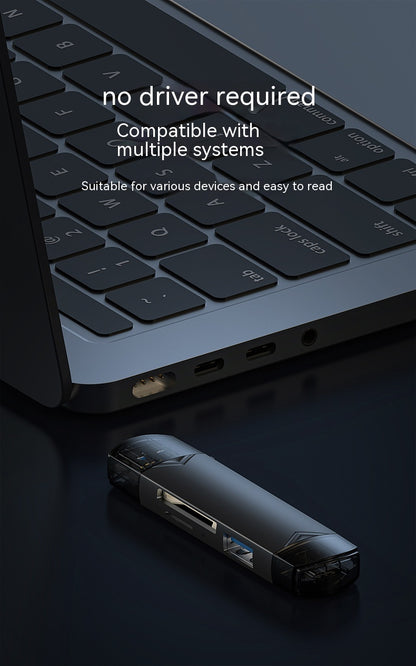 Laptop with USB drive on a dark surface, highlighting compatibility and ease of use.