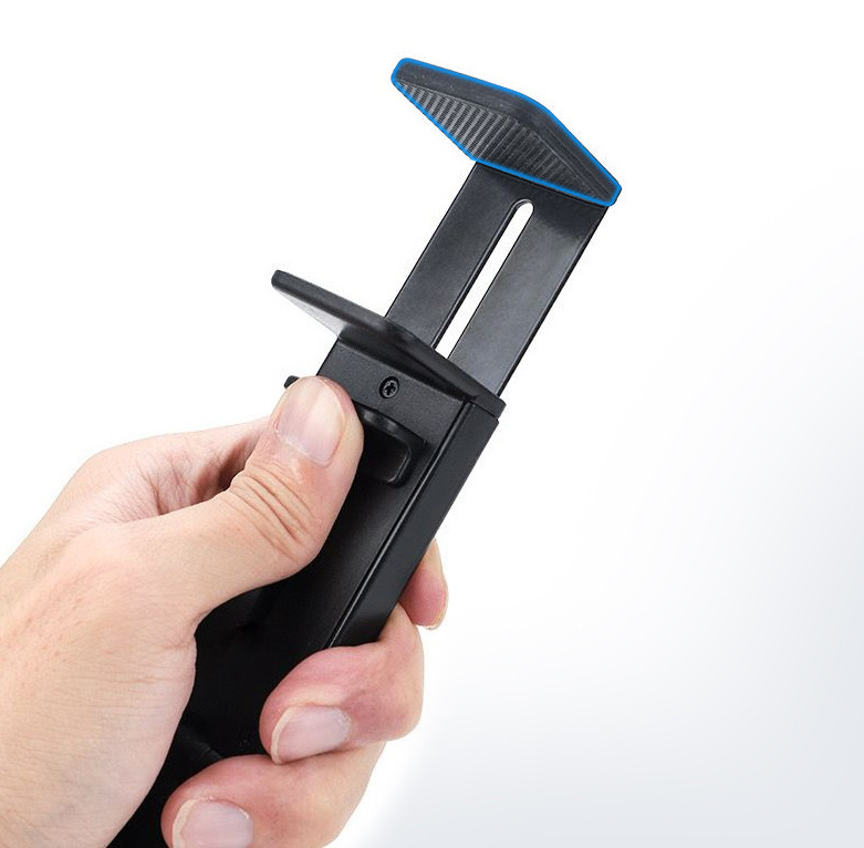 Hand holding a black phone holder with blue accents on a white background