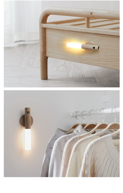 Wooden wall lights on a bed and clothing rack with hangers.