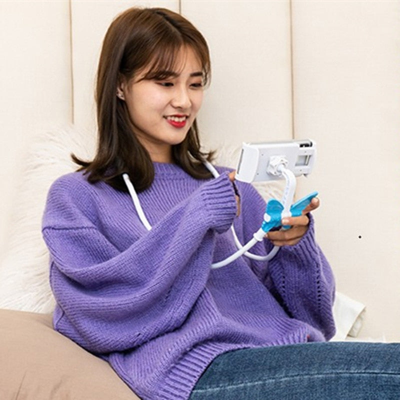 Woman in a purple sweater holding a smartphone with a blue grip and white strap.