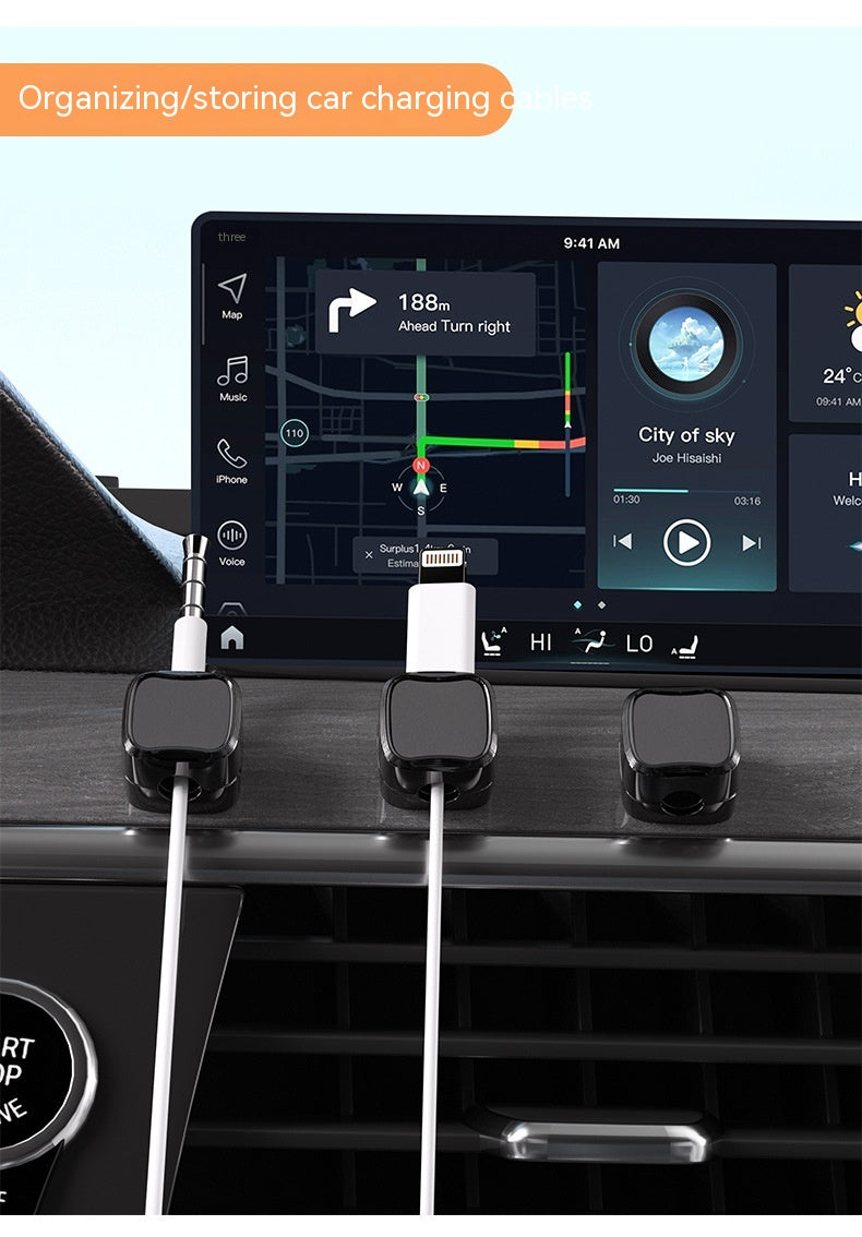 Car dashboard with charging cables and a navigation screen displaying directions.