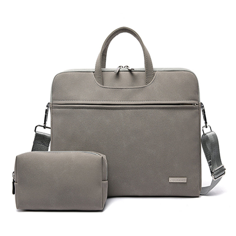Gray travel bag with shoulder strap and smaller pouch on a white background