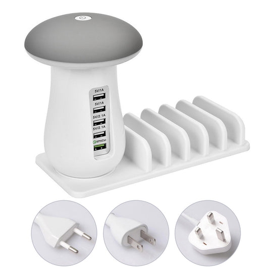 White and gray electronic device with multiple ports and plug illustrations on a white background