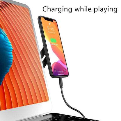 Phone charging via cable with text 'Charging while playing' displayed on a screen.