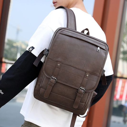 Person wearing a brown leather backpack with a blurred background