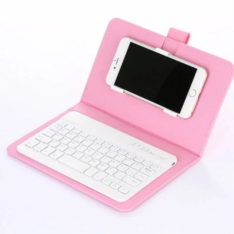 Pink case with white keyboard and smartphone on a white background