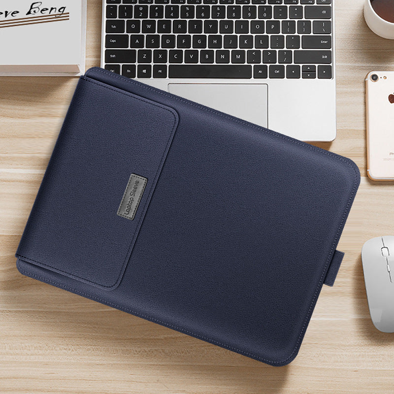 Navy blue laptop sleeve on a desk with a laptop, phone, and mouse.
