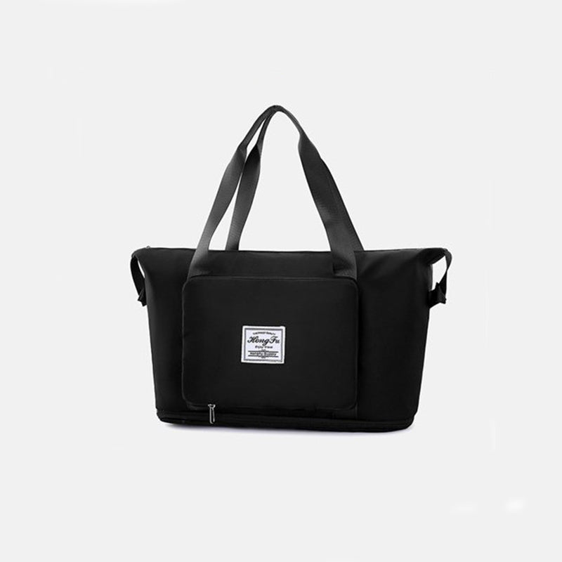 Black duffel bag with a visible brand label on a light gray background