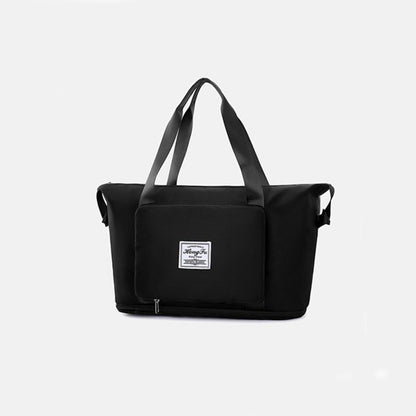 Black duffel bag with a visible brand label on a light gray background