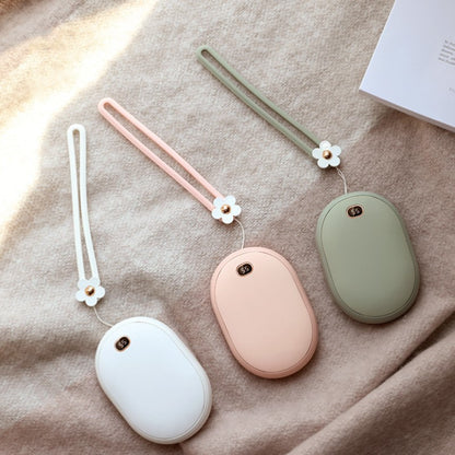 Three small oval-shaped devices with floral straps on a textured surface