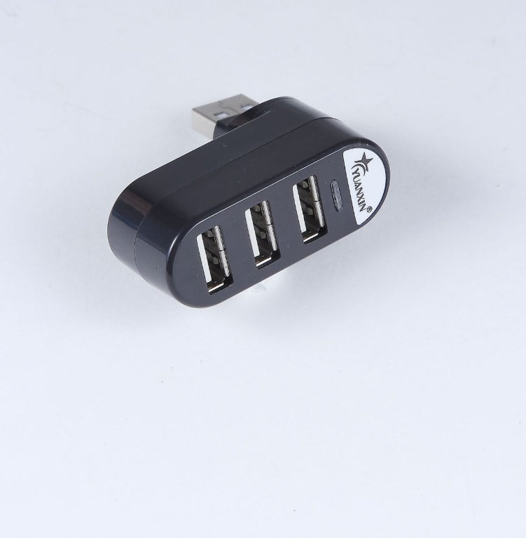 Black USB hub with four ports on a white background