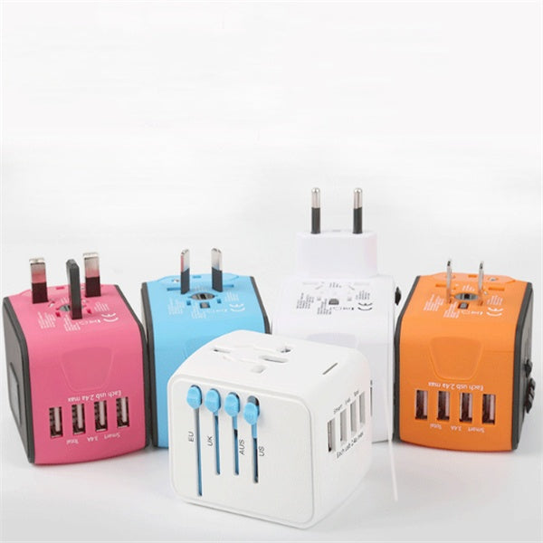 Four colorful travel adapters on a white background