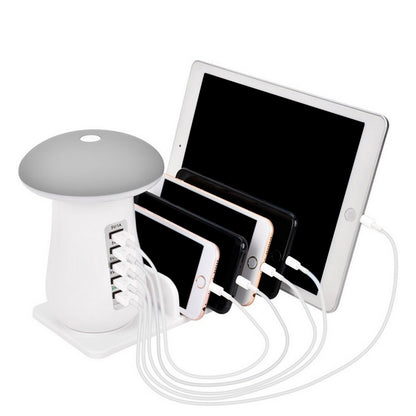 White multi-device charging station with smartphone, tablet, and smartwatch on a white background
