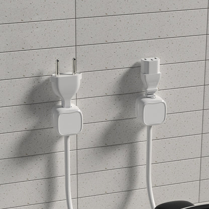 Two white electrical plugs against a gray tiled wall.