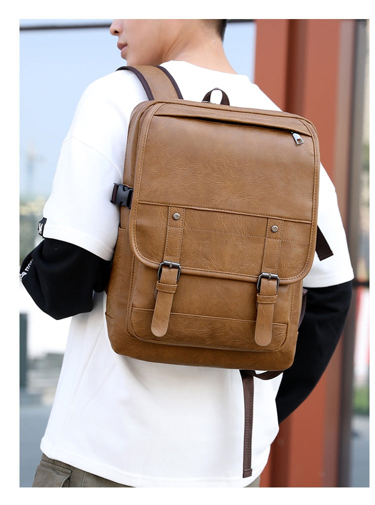 Person wearing a brown backpack outdoors