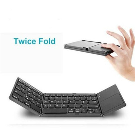 Foldable keyboard with a hand demonstrating its compact size on a white background
