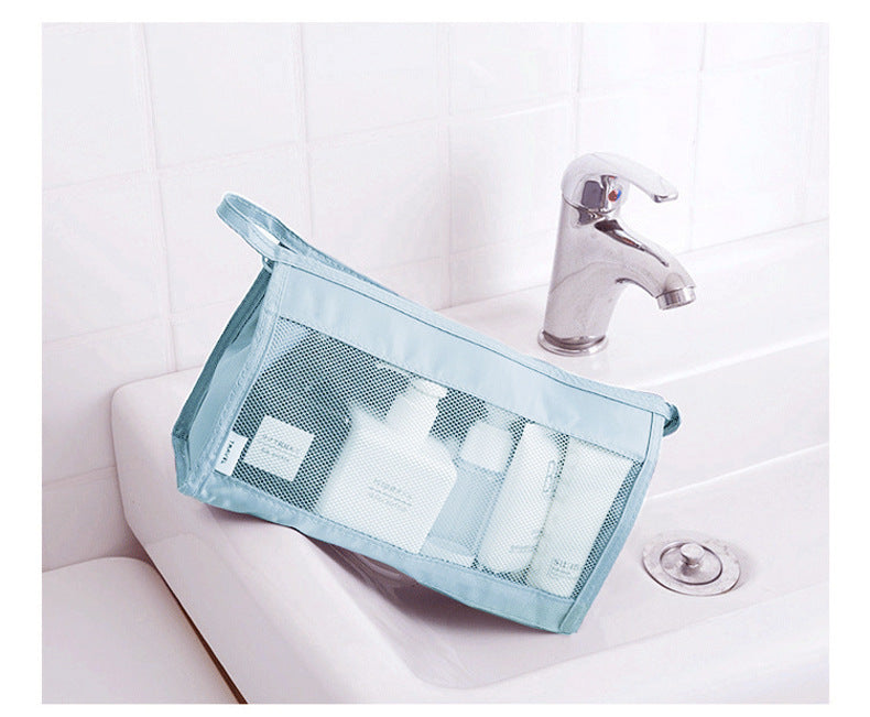 Clear mesh bag with toiletries on a bathroom sink