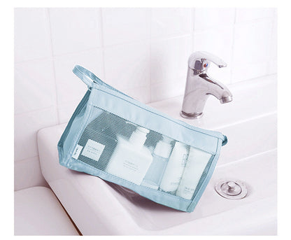 Clear mesh bag with toiletries on a bathroom sink